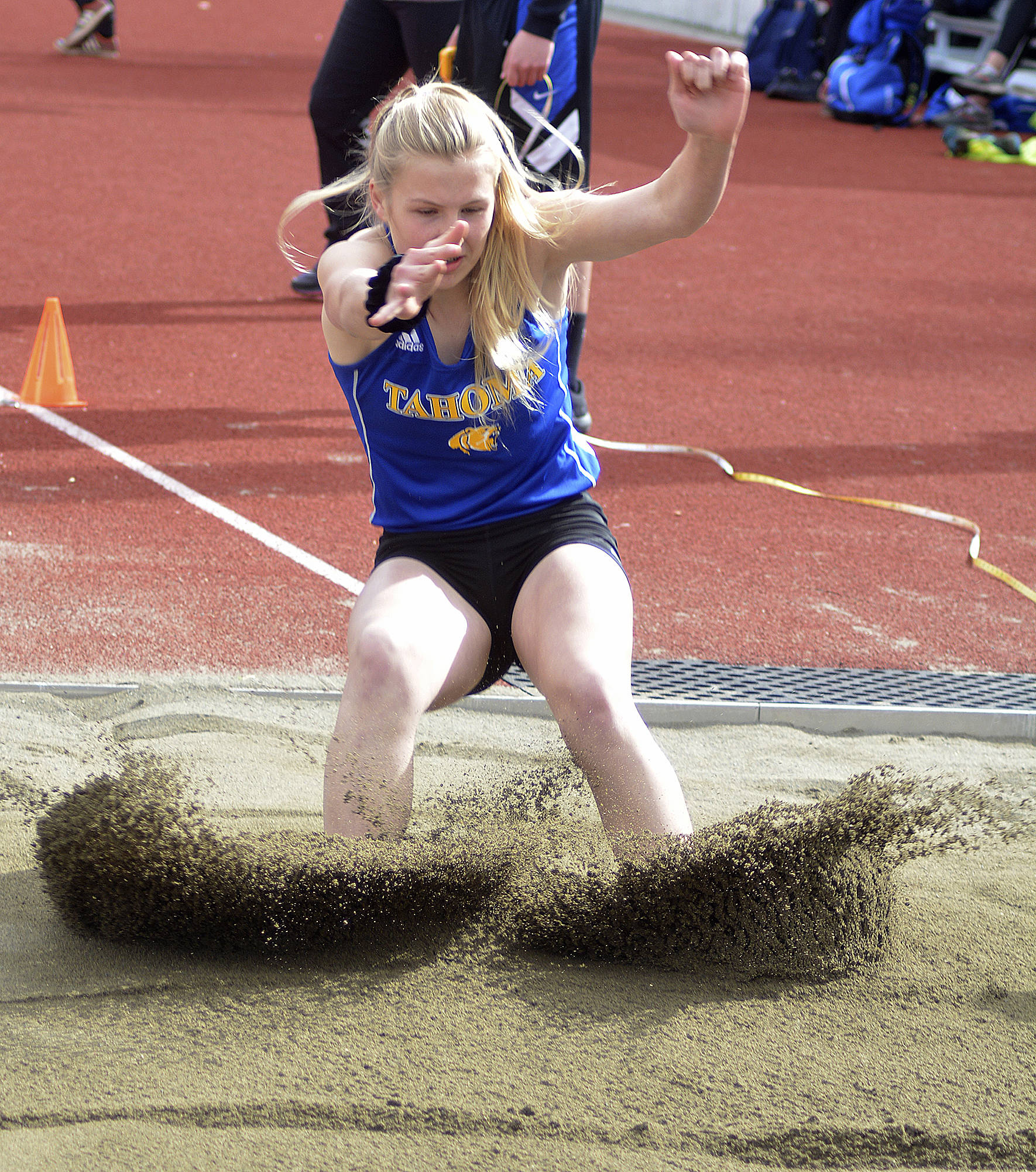 Tahoma track student Katie Welsh leaps into the sand during the long jump. File photo by Kayse Angel