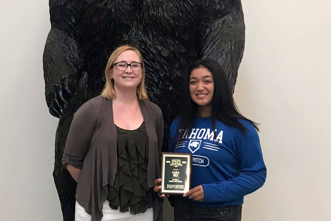 Photo by Kayse Angel                                 Kaiea Higa (right), a freshman fast pitch player for the Tahoma High School Bears, won the first ever Female Athlete of the Year award from the Covington-Maple Valley Reporter. She received a special plaque from the Reporter’s editor Danielle Chastaine (left).