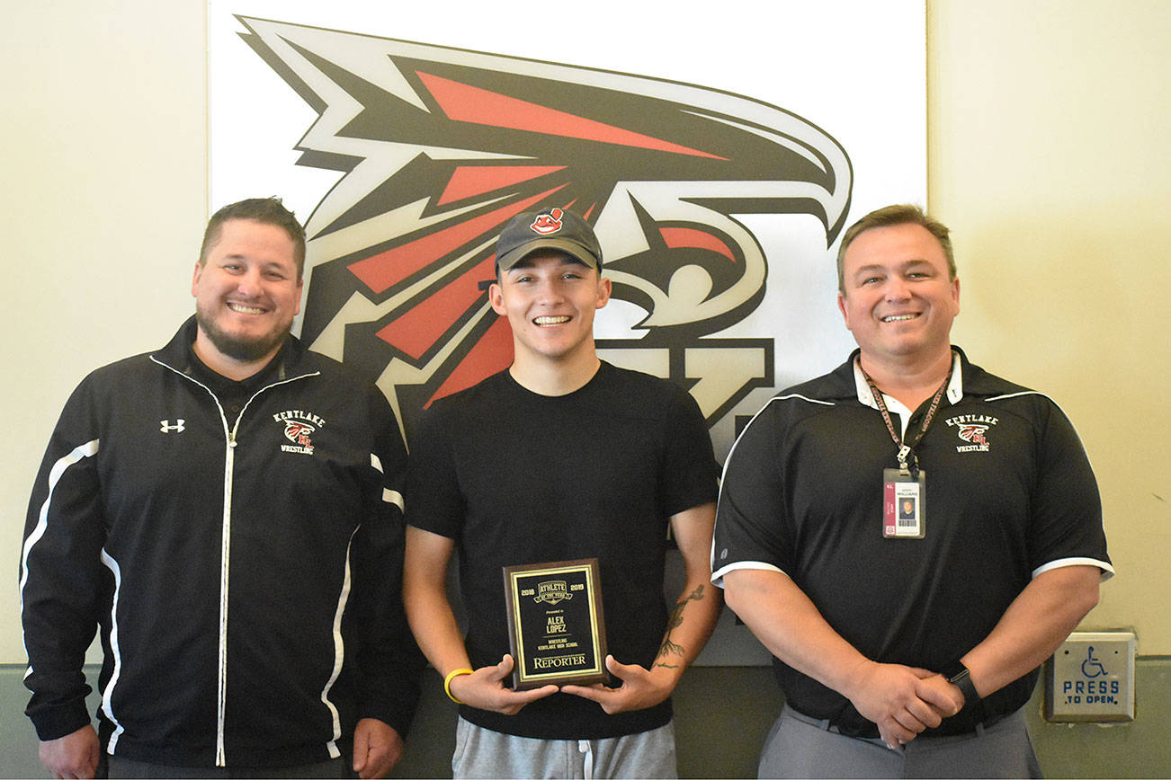 Alex Lopez (middle), is a wrestler and a senior at Kentlake High School. He was the winner of the Reporter’s Athlete of the Year. Coach Jeremy Williams (right) and coach Michael Andrews (left) said Lopez’s attitude and committment earned him the award.