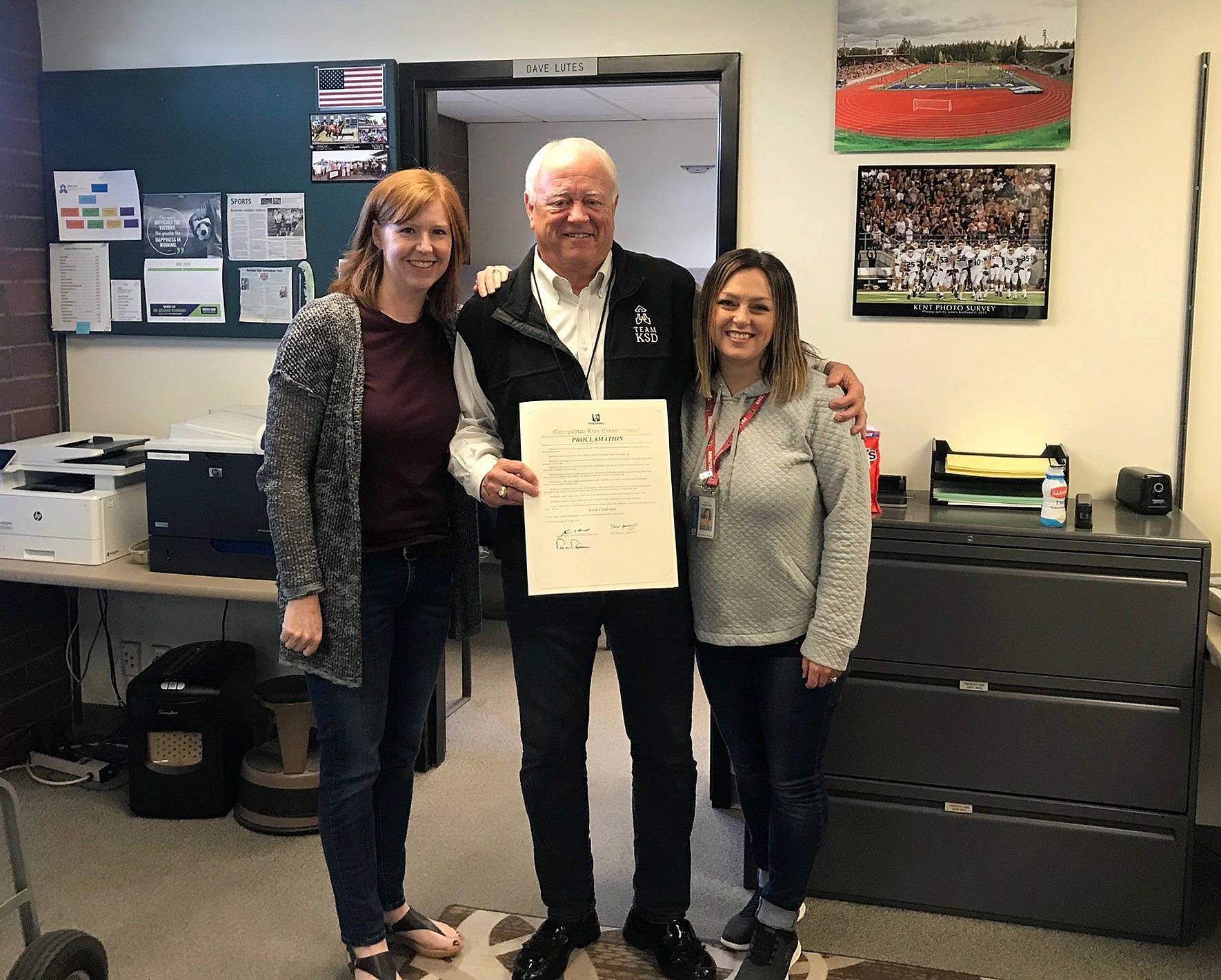 Submitted photo from King County Council.                                 Dave Lutes holds the proclamation from the King County Council declaring June 7 as ‘Dave Lutes Day’ with Amy Erickson and Holly Potts with the Kent School District.