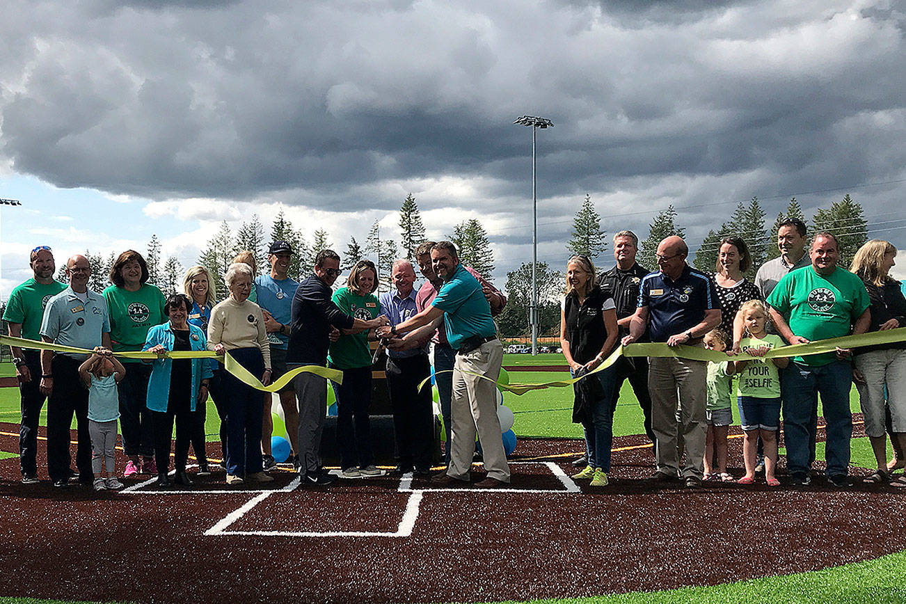 City staff and council members cut the ribbon during the Summit Park ribbon cutting on July 18. Photo by Kayse Angel
