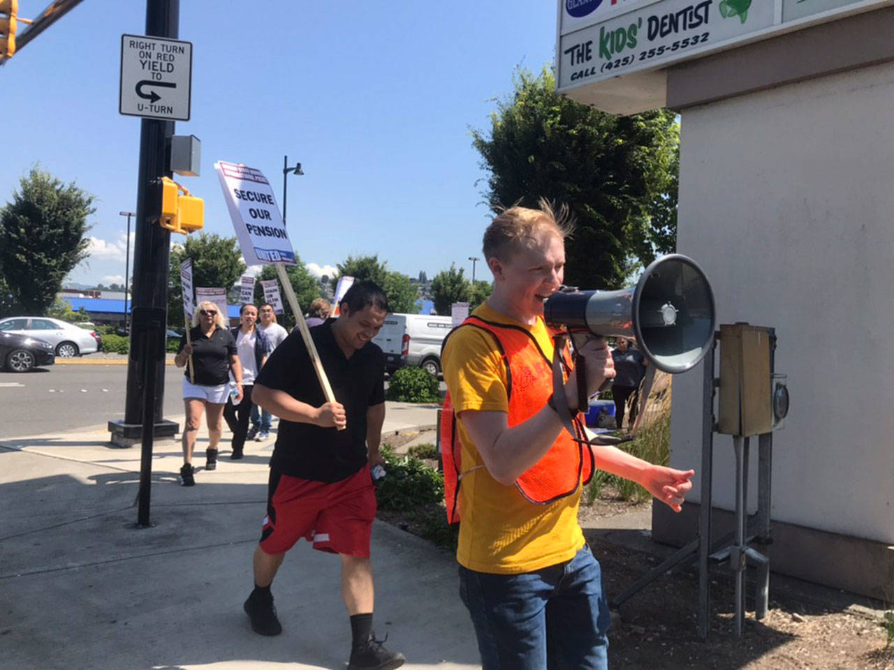 Grocery store union workers picket outside of a Renton Fred Meyers on July 31. They are in contract negotiations with Kroger for higher wages, predictable scheduling and better safety conditions. Haley Ausbun/staff photo