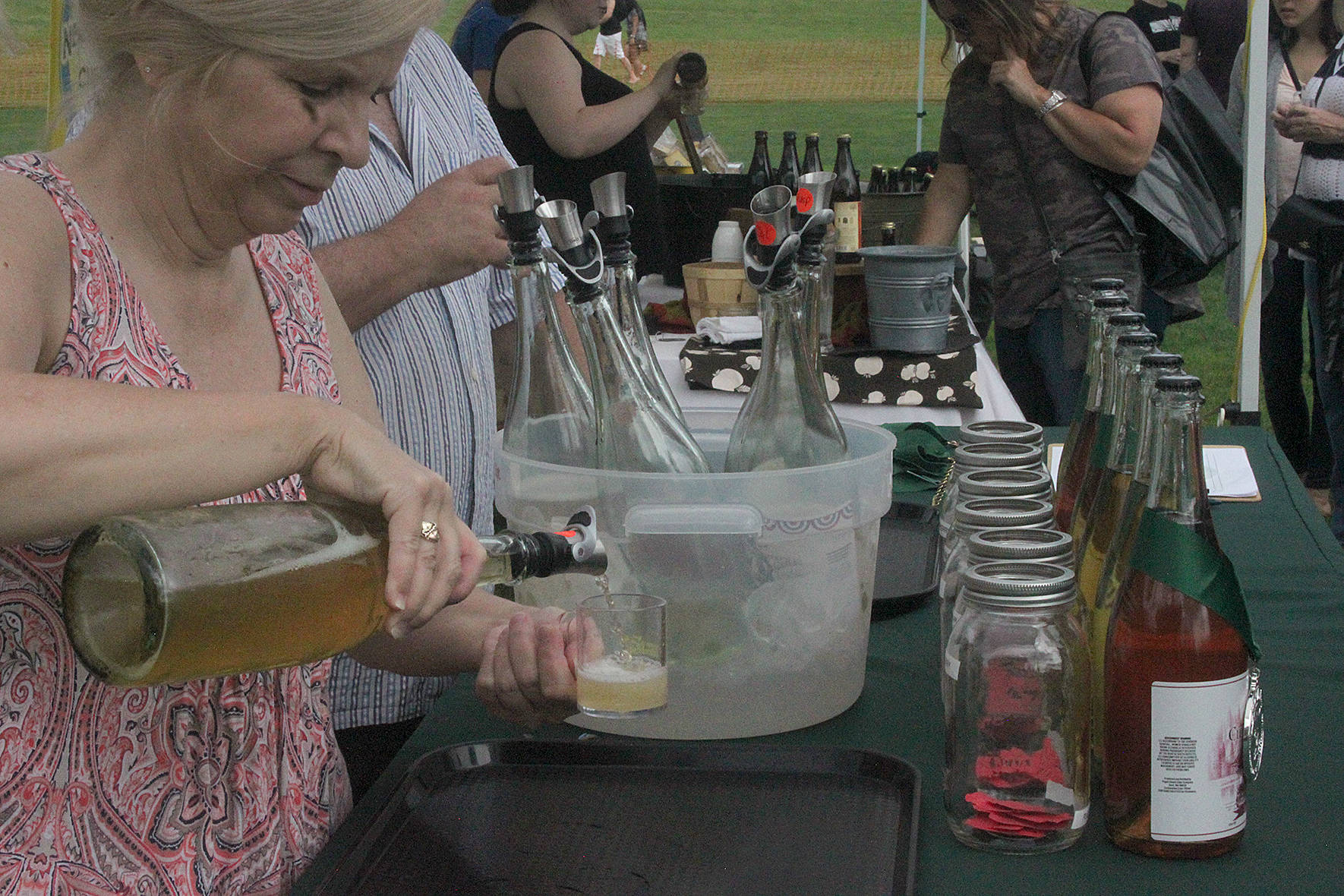 The cider poured into multiple sample cups while local brewers gave away tastes at the 2019 Sausage and Cider Fest.