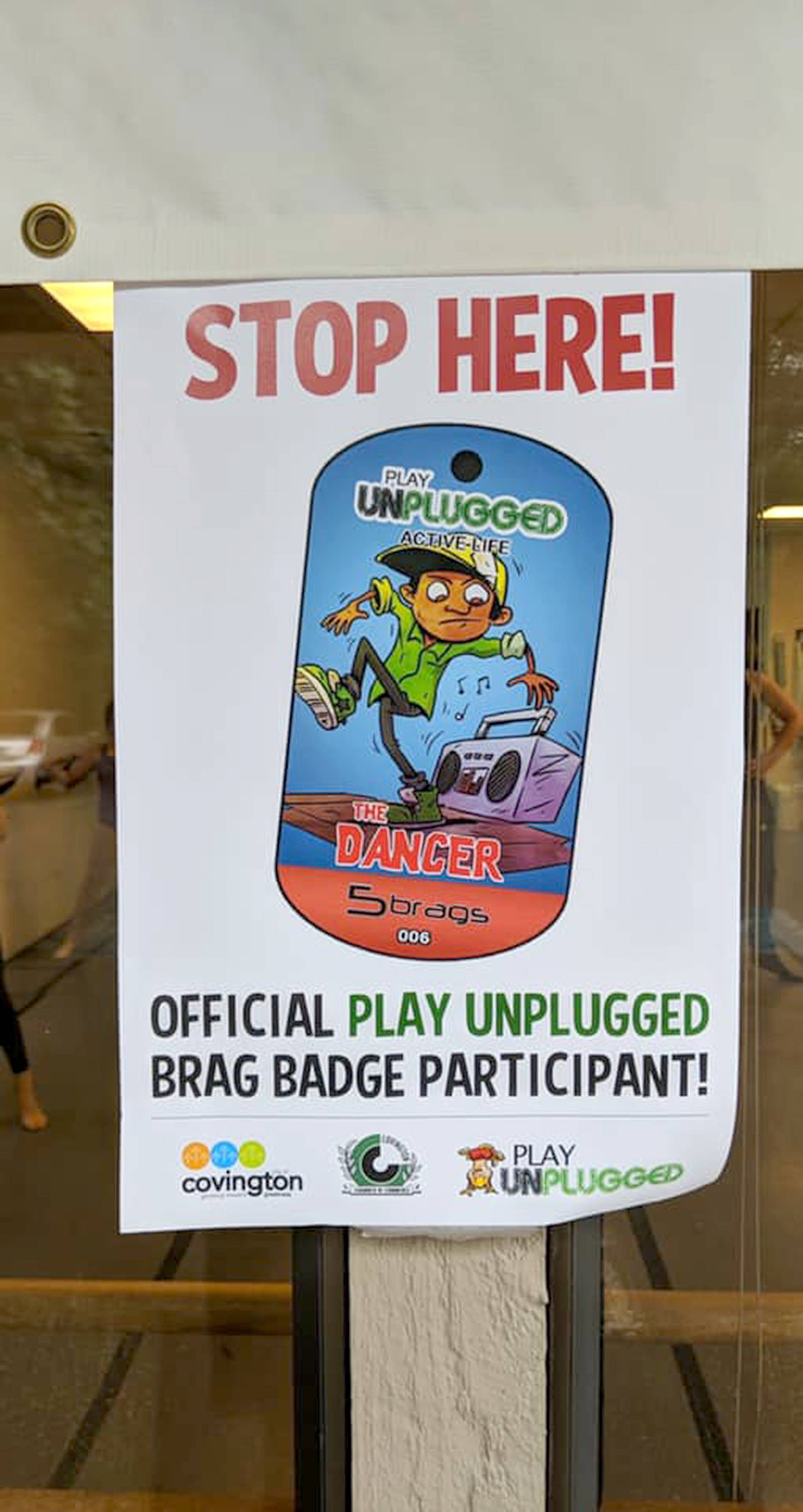 A sign shows what local businesses are participating in the Play Unplugged challenge, hosted by the Covington Chamber of Commerce and the Kent School District. Photo courtesy of the Covington Chamber of Commerce.