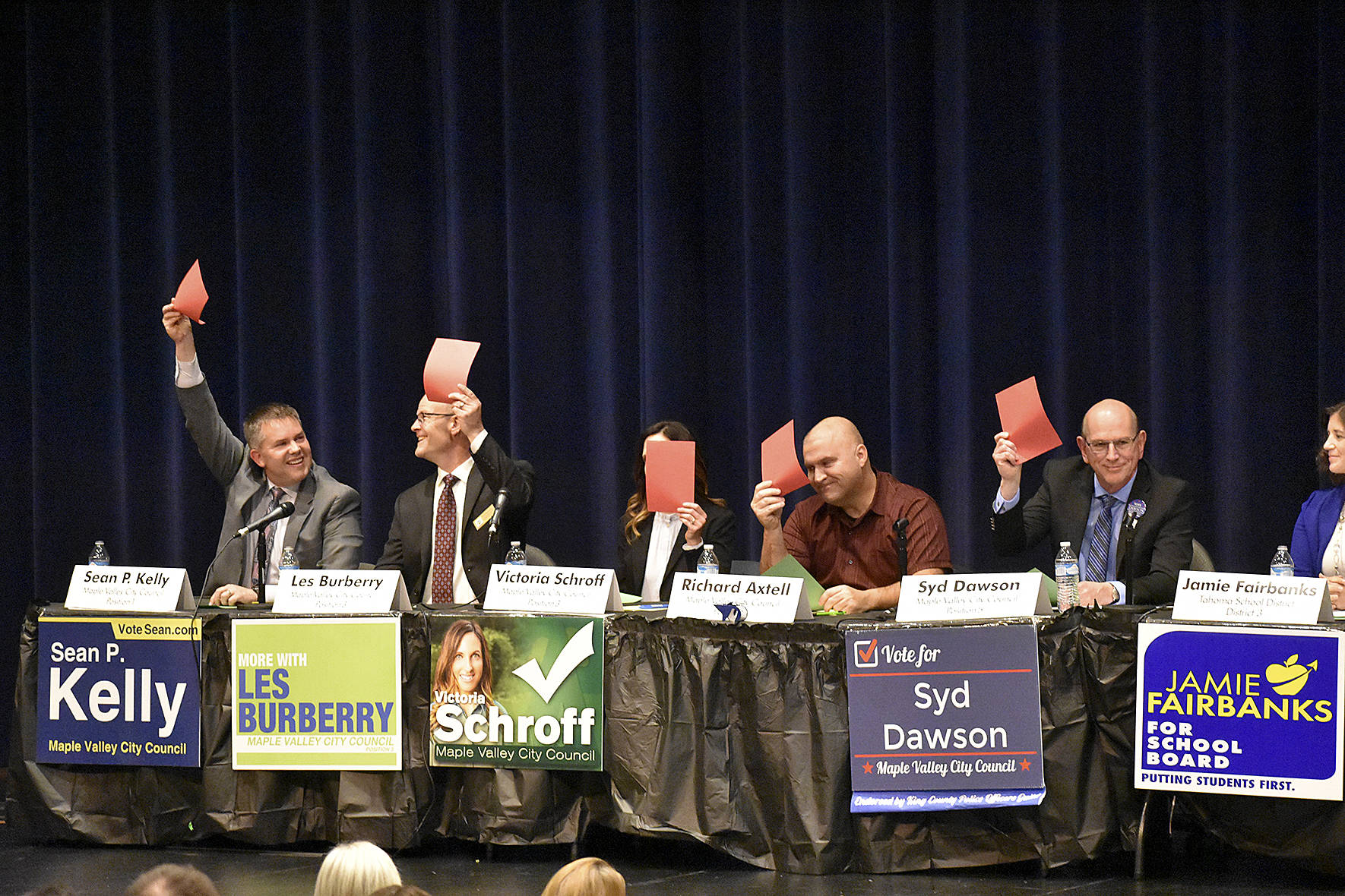 Photo by Haley Ausbun. One segment of the Maple Valley Candidate forum, Oct. 17 at Tahoma High School, included asking candidates yes or no questions by raising a red or green card. All city candidates, Sean Kelly, Les Burberry, Victoria Schroff, Richard Axtell and Syd Dawson raised a card to indicate no on a question.
