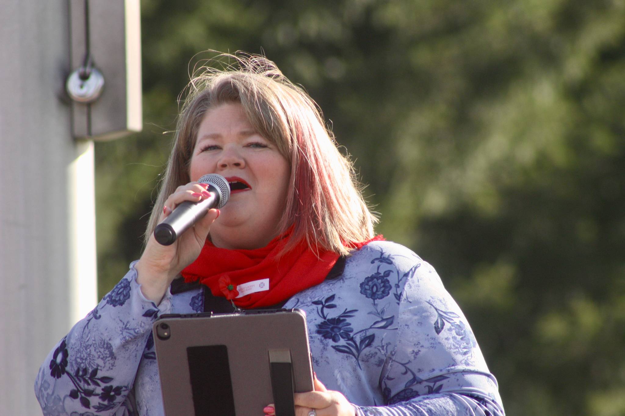 Lindsey Delmarter sings “God Bless America” during the program at Tahoma National Cemetery. MARK KLAAS, Kent Reporter