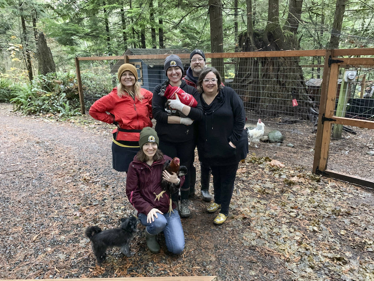Volunteers help out at a Sunday work party at Rooster Haus Rescue in Fall City. From left, top: Jenny Rae, Littles the dog, Nikki Waters, John Higgins, Gina Erskine. From left, bottom: Yoshi the dog, Ashley Ventura, Manny the rooster. Natalie DeFord/staff photo