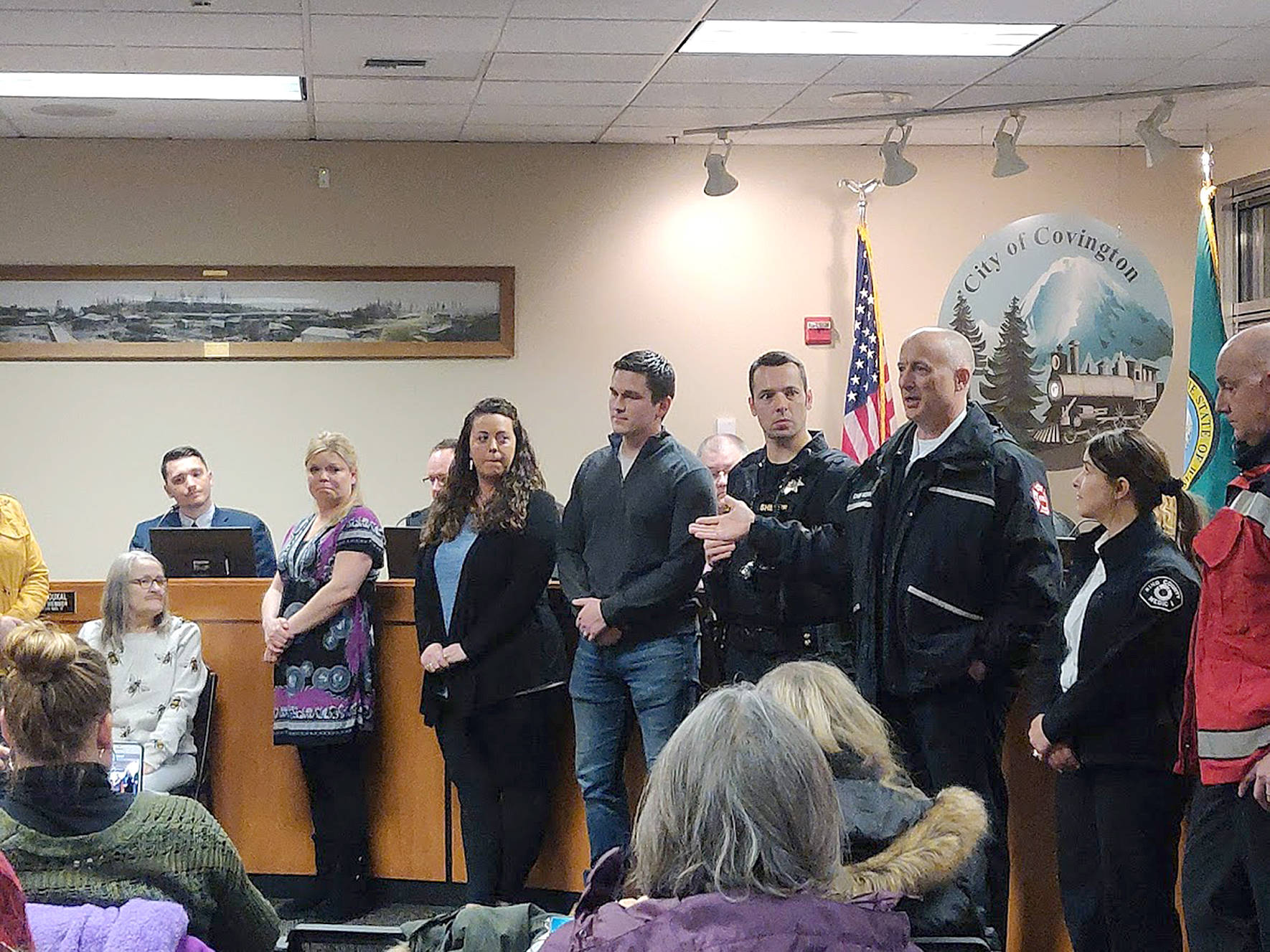 A large group of audience members and honorees listed to Puget Sound Regional Fire Authority Captain Joe Root speak about how CPR can save a person’s life during an emergency during the regular Covington City Council meeting on Monday, Jan. 27, 2020. Photo by Danielle Chastaine.
