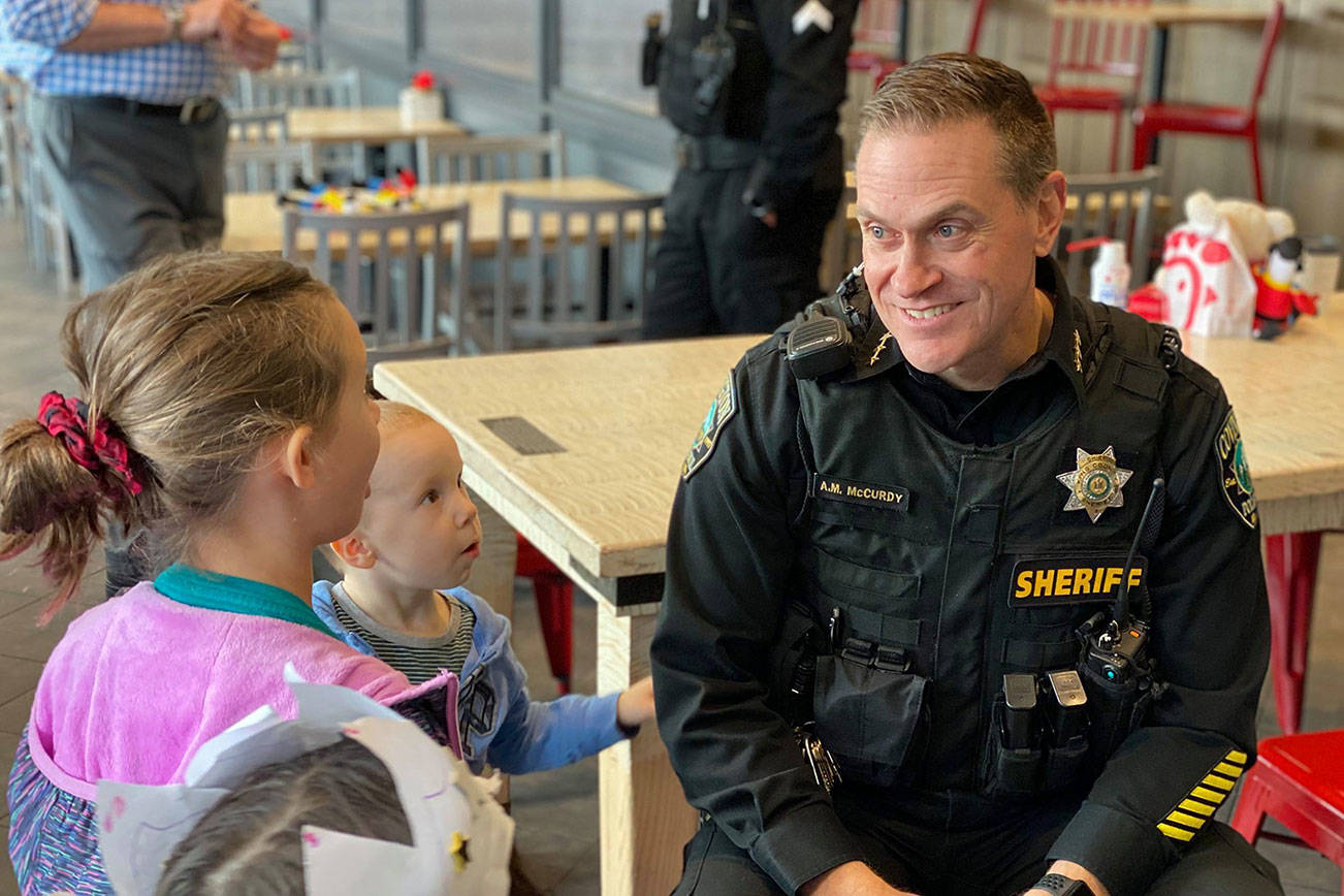 Covington Police Chief Andrew McCurdy speaks with local kids about police work and safety during the Coffee with a Cop event at the Covington Chick-fil-A on Monday, Feb. 10, 2020. Photo courtesy of the City of Covington.