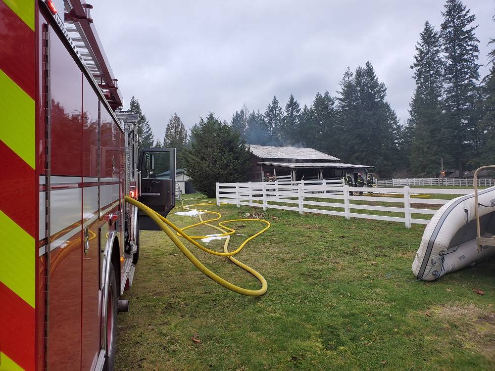 A 300-foot long hose stretches across a Covington property after a barn caught fire the morning of Friday, Feb. 14. Photo courtesy of the Puget Sound Regional Fire Authority.