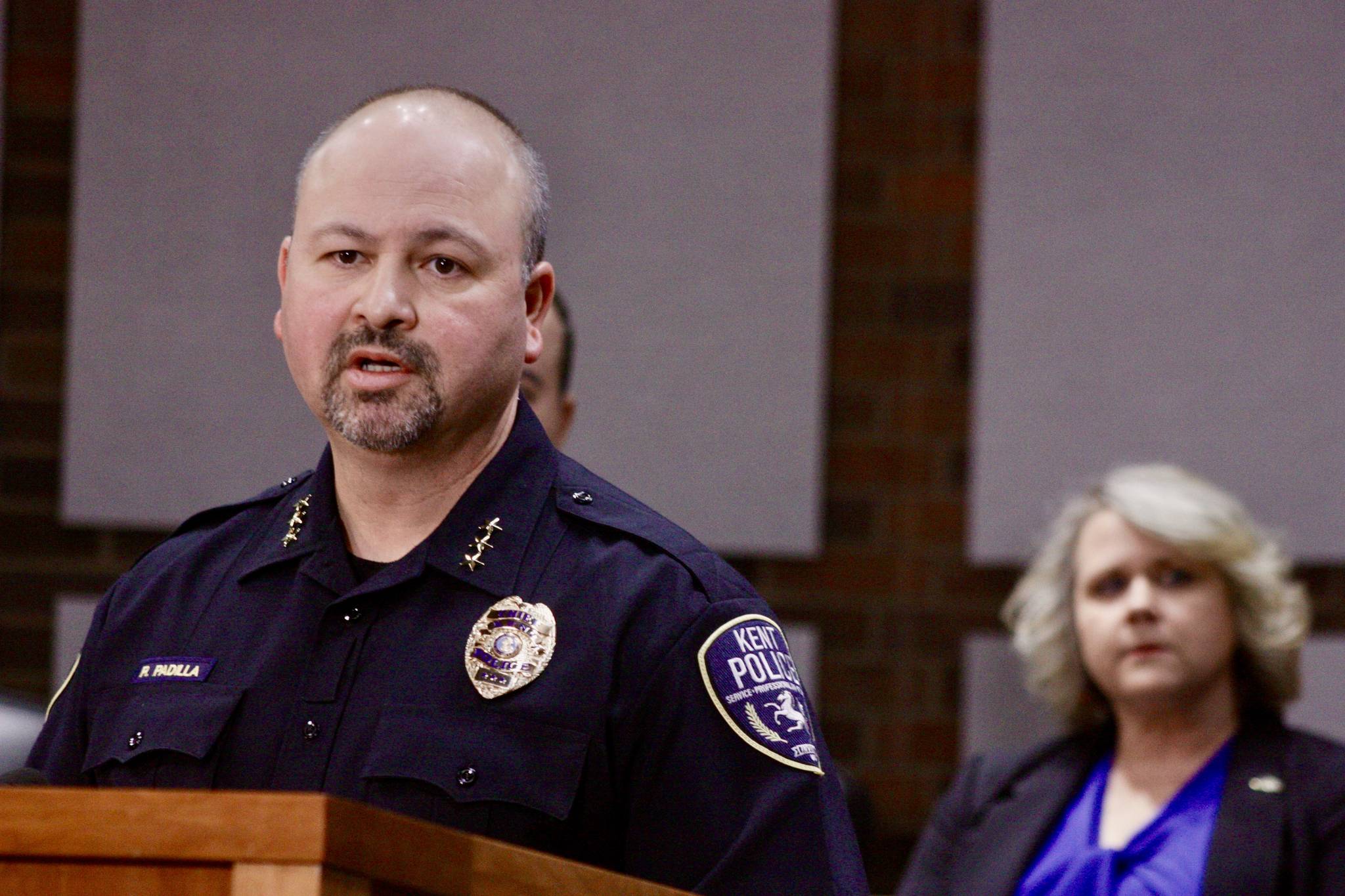 Kent Police Chief Rafael Padilla, with Mayor Dana Ralph listening, talks to the media about the King County-owned quarantine/isolation facility in Kent during a news conference Friday. City officials are concerned about the safety of the former Econo Lodge motel after a patient fled from the facility, shoplifted a convenience store and boarded a bus. MARK KLAAS, Kent Reporter