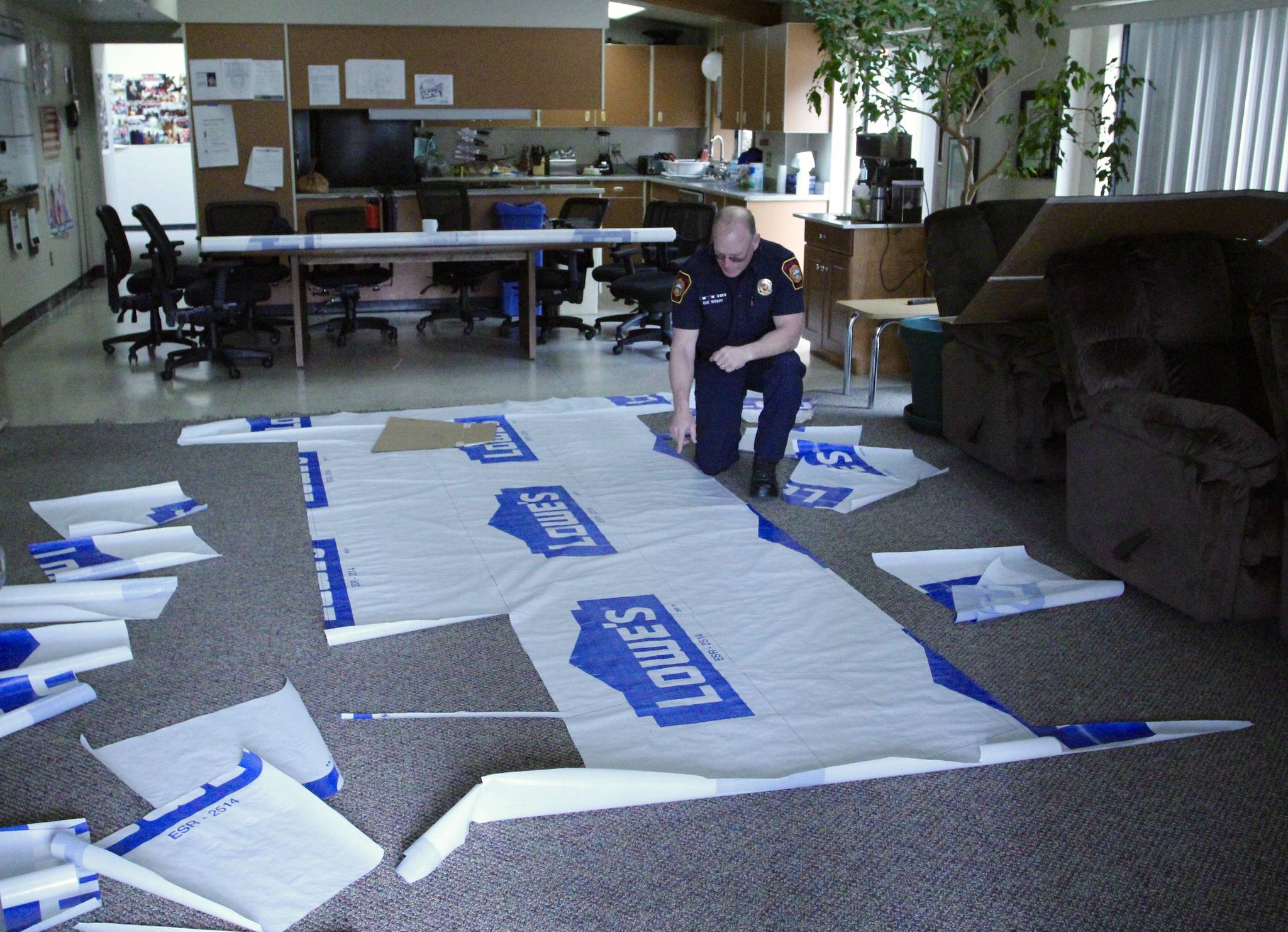 Sheets of Tyvek are kept in Station 65’s dayroom for crew members to cut out the gown pieces. Olivia Sullivan/staff photo