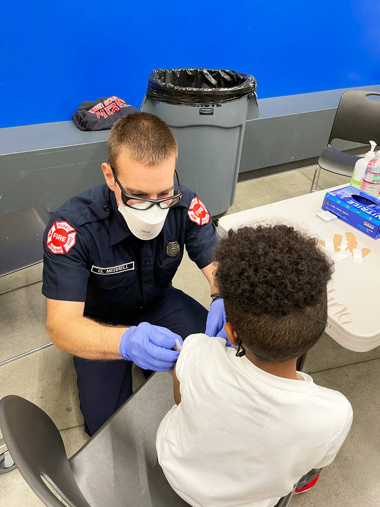 A Puget Sound Fire employee administers a COVID-19 shot Dec. 1 to a Tahoma School District student. COURTESY PHOTO, Puget Sound Fire