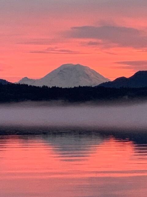 Photo courtesy of Abbie Crane, who writes that on Jan. 12, 2022, “I walked on the East Lake Sammamish Trail at about 4:30 p.m. The combination of a colorful, beautiful sunset and a bank of fog on the lake made these pictures very special. Mt. Rainier made an appearance.”