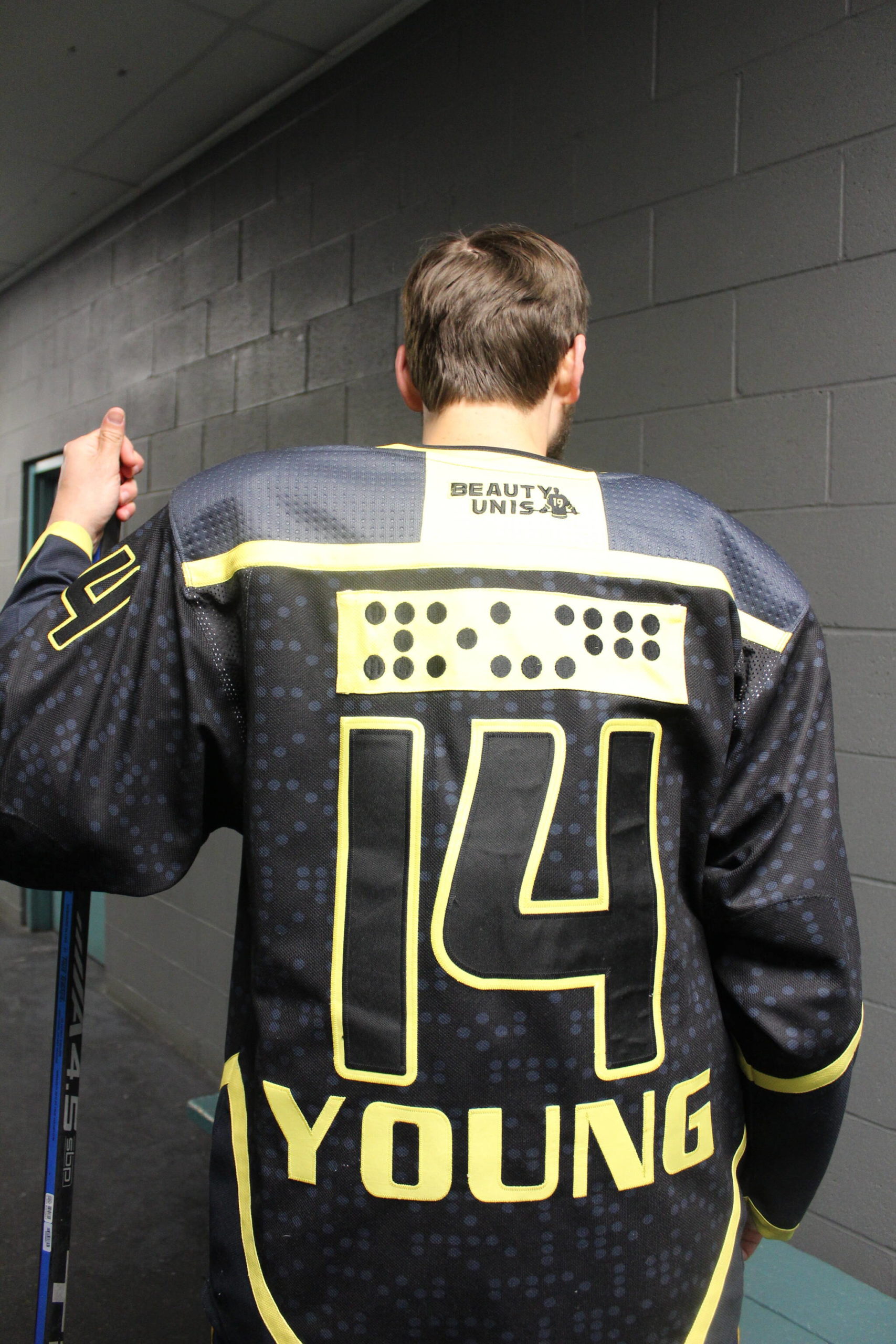 Adam Young’s hockey jersey spells out his name in braille. Photo by Bailey Jo Josie/Sound Publishing