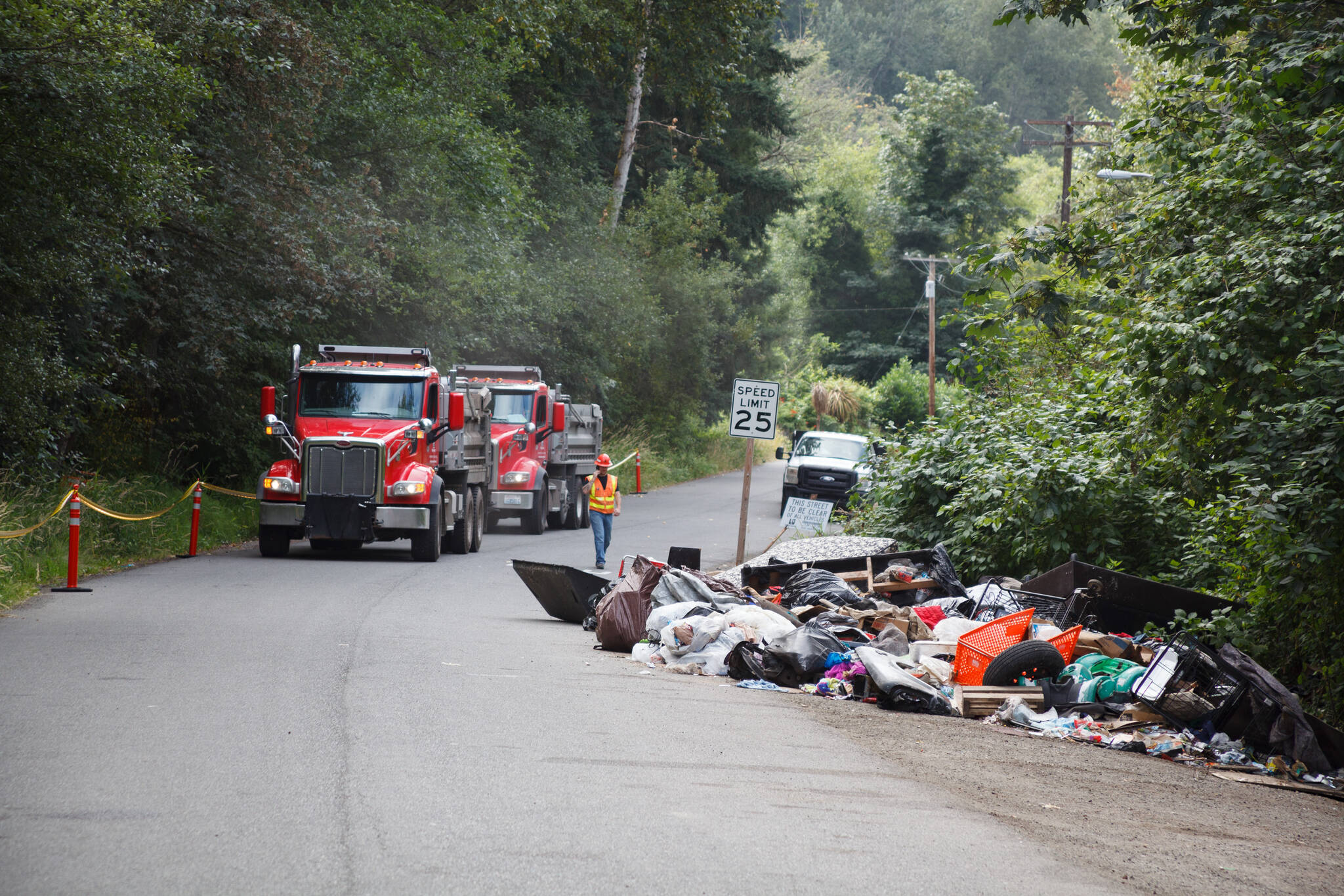 County workers cleaned trash and debris along the Green River Road in unincorporated King County. Henry Stewart-Wood/Sound Publishing