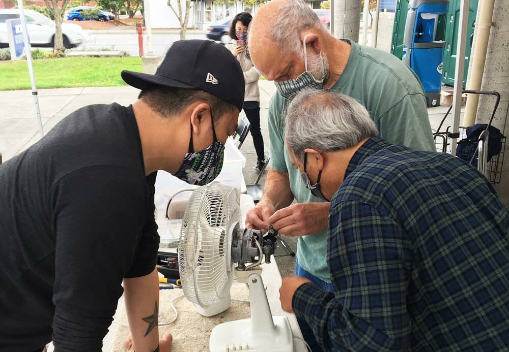Volunteer “fixers” attempt to repair a fan at one of King county’s 2021 repair events. Photo courtesy of King County Solid Waste Division.