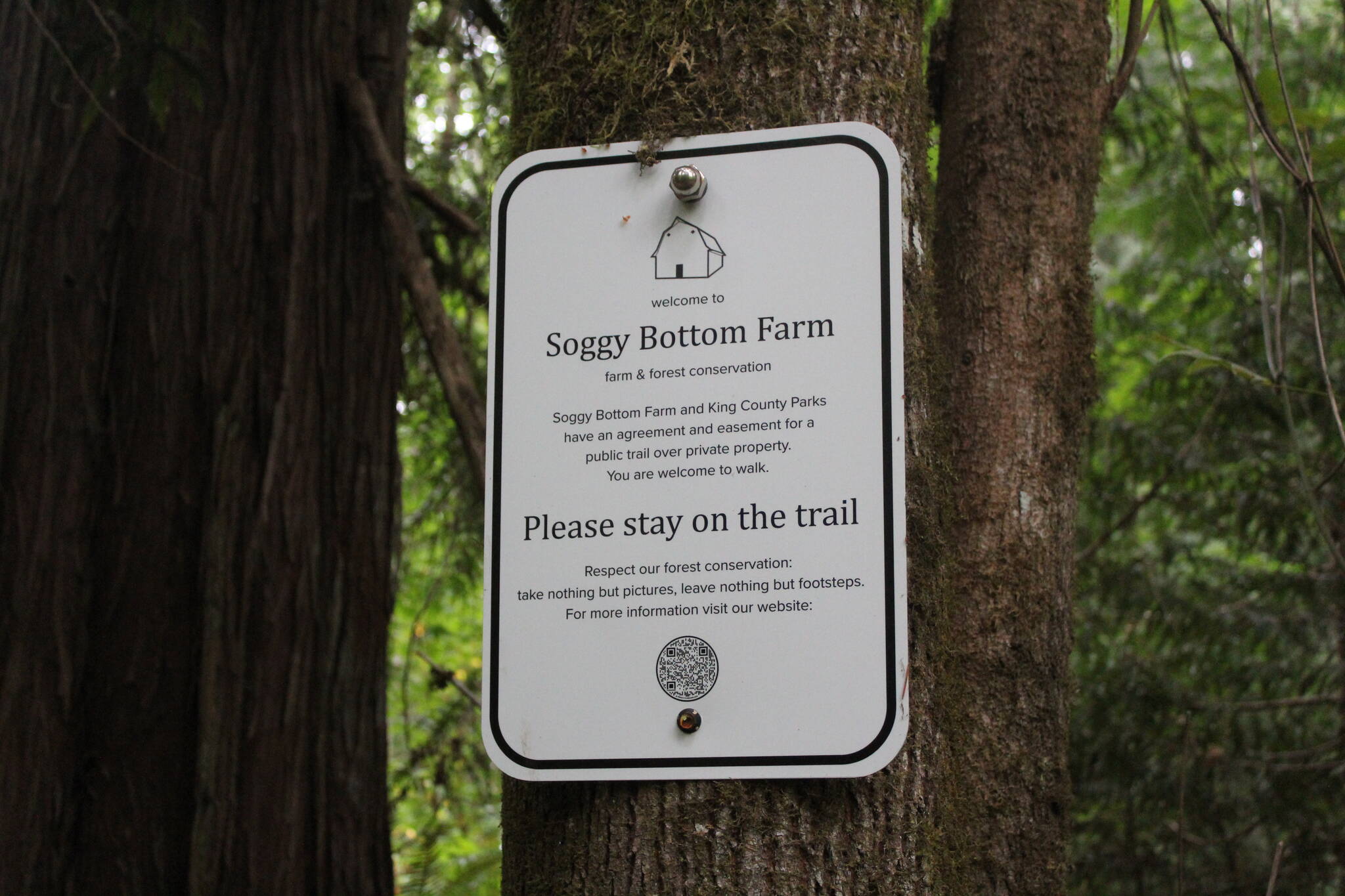 A sign along the trail on Soggy Bottom Farm explaining the agreement and easement between the farm and King County Parks, with a QR code to the farm’s website. Photo by Bailey Jo Josie/Sound Publishing.
