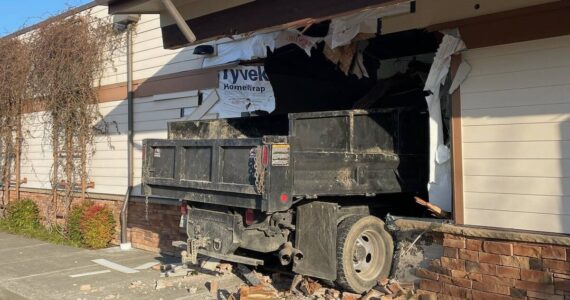 The truck was in the parking lot near the Maple Valley Eye Care Center before crashing into the building. Photo courtesy of Puget Sound Regional Fire Authority.