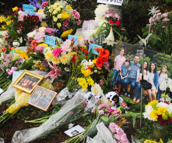 Flowers, framed photos, plush toys and a QR code to the GoFundMe pages of the families grace the memorial site after the March 19 crash. Photo by Bailey Jo Josie/Sound Publishing.