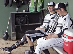 Kentwood’s Avery Kain jokes around with teammate Lucas Gately in the dugout during a game against Kentridge.