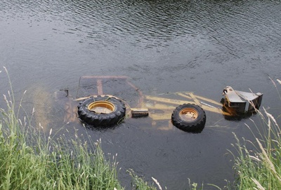A Potelco backhoe slide into the Green River today and was pulled out by tow trucks.