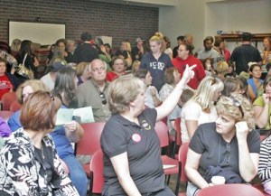 Kent teachers fill the Kentlake High School gym Wednesday evening for a meeting of their union