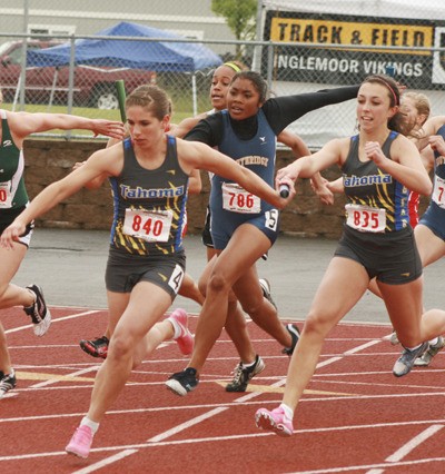 Mande McKinney takes the baton from Paige Hammock in the 400-meter relay preliminaries May 28.  Tahoma won the state gold medal in the event.