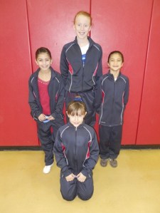 The Summit Gymnastics Girl's Artistic Team at the Washington Fall State Championship.  (Left to right) Zeah Lucero