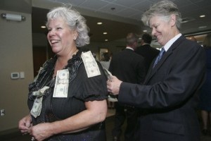 Nancy Monahan pins her donation to Ginger Passarelli on Sept. 10 at Meridian Valley Country Club.