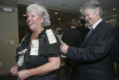 Nancy Monahan pins her donation to Ginger Passarelli on Sept. 10 at Meridian Valley Country Club.