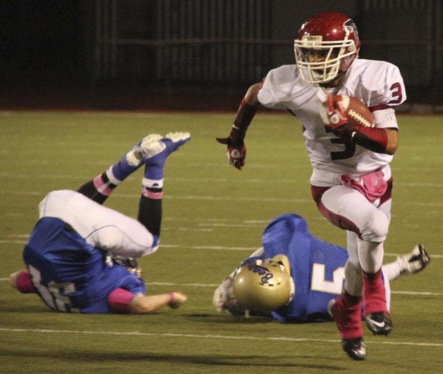 Kentlake’s Jordan Laurencio breaks two tackles against Tahoma Oct. 19. Laurencio racked up 163 yards on the ground on seven carries along with a touchdown in the Falcons’ 49-22 win.