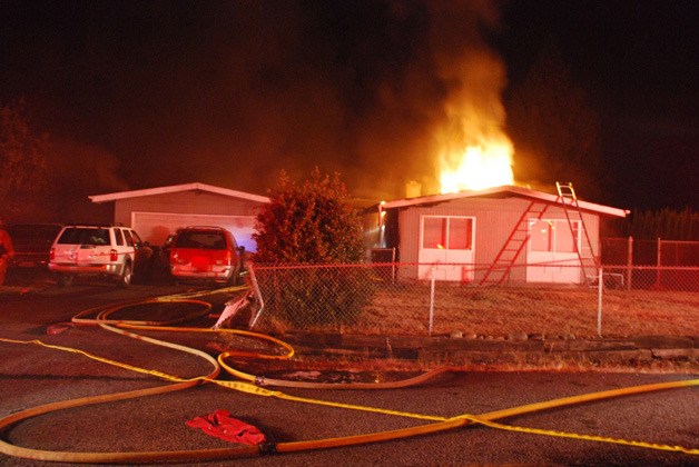 Kent and Maple Valley firefighters respond to an early morning fire in Covington.