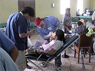 Dr. Joel Rude examines a woman’s teeth in  El Paraiso in Guatamala. Rude traveled  with  three other dentist and a medical  team to the village.