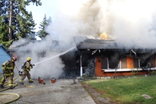 Kent firefighters battle a blaze in the 19400 block of Southeast 267th Street in Covington that displaced a family of six on Thursday.