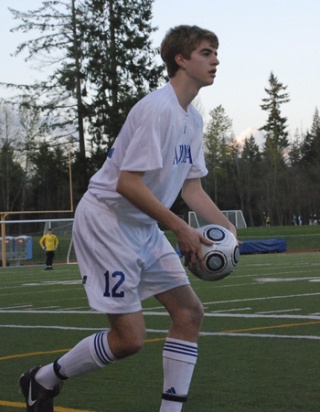 Tahoma defender Chris Marx winds up to throw in the ball during the first half against Kentridge Friday. The Chargers held onto first place with a 2-1 win over the Bears at Tahoma.