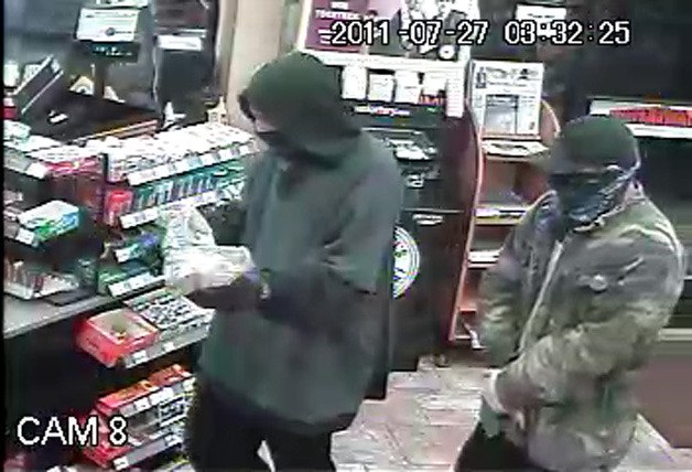 Two of the robbers in one of the convenience stores. The suspects are still at large.