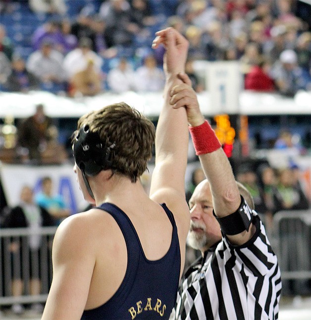 Tahoma senior Adam Hokenson gets his hand raised in victory during the 2014 Mat Classic.