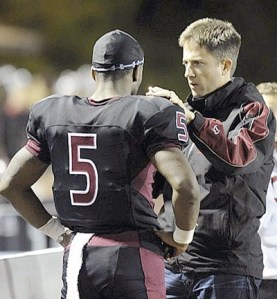 Dr. Jason Brayley checks out former Kentlake football player on the sidelines after a hard hit during the 2011 season.