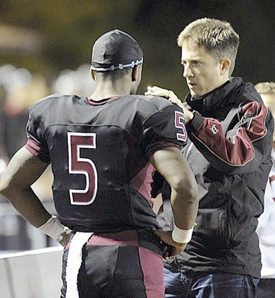Dr. Jason Brayley checks out former Kentlake football player on the sidelines after a hard hit during the 2011 season.