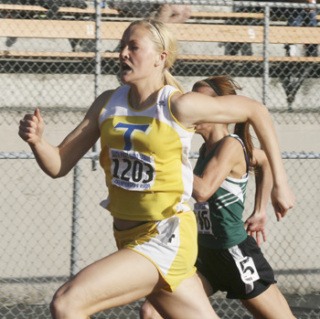 Tahoma's Savannah Johnson surges ahead to win the 200-meter sprint Friday at Kent-Meridian during the South Puget Sound League subdistrict tournament.