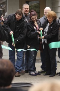 Family members of Detective Michael Raburn and Sgt. Samuel Hicks helped cut the ribbon to officially reopen Precinct 3 in Maple Valley on Tuesday morning.