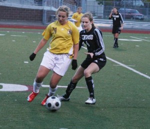 Kentwood's Reilly Retz battles for the ball Saturday at Mount Tahoma High. The Conks beat South Kitsap 1-0 and advance to the semifinals against Skyline.