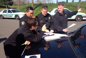 King County Sheriff's Office deputies prepare Friday to search Kentwood High School in Covington after a threatening email to school officials.