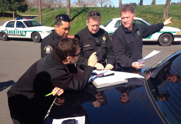 King County Sheriff's Office deputies prepare Friday to search Kentwood High School in Covington after a threatening email to school officials.