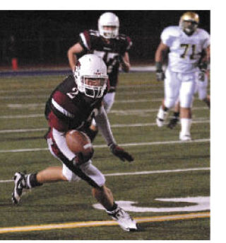 Kentlake wide receiver Cody Arp takes in a pass and looks to gain more yardage last Friday against Auburn. Arp pulled in five receptions for 54 yards in a 42-7 loss to the fifth-ranked Trojans.