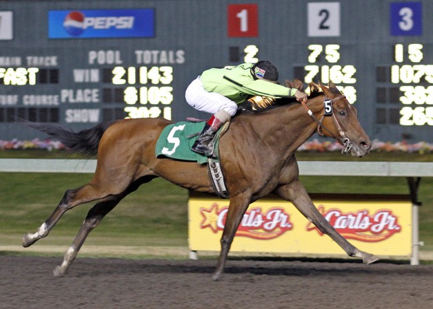 Ron and Debbie Maus' Candy for Debbie with Leslie Mawing riding finishes in full stride while winning the feature race for 3-year-olds at Emerald Downs in 1:38.51 for one mile.