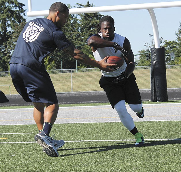 Demitrius Bronson (right) practices with his mentor/trainer/best friend James Laurence at Kentwood High School. Bronson