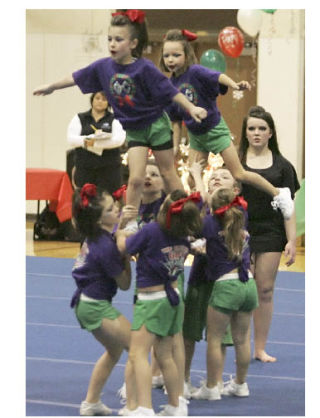 The Galaxy Cheer Mini team performs during Kentwood High School’s Holiday Invitational cheerleading competition. The 60-performance event Dec. 6 was a fund-raiser for the Kentwood cheerleaders.