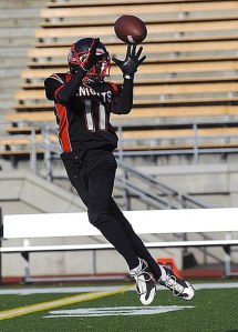 A Kent youth football player catches the ball during a game. The uniforms will be changing this upcoming season.